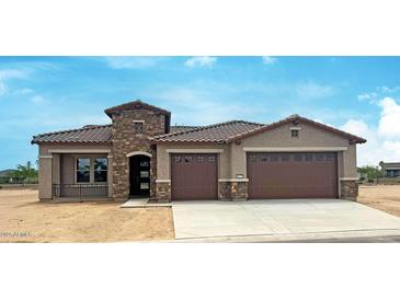 Charming home showcases a stone facade accent, dual-car garage, and desert landscaping at 16777 W Sheila Ln, Goodyear, AZ 85395