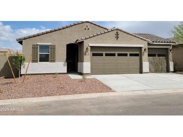 Charming single-story home with a two-car garage and desert landscaping at 20795 N Roadrunner Ln, Maricopa, AZ 85138