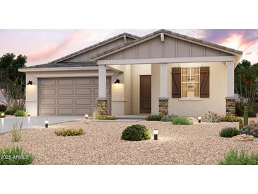 Inviting single-story home featuring a two car garage and desert landscaping with accent lighting at 39980 W Sparks Ln, Maricopa, AZ 85138