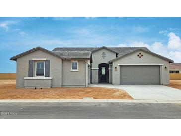 Charming single-story home featuring a neutral color palette, well-manicured yard, and an attached two-car garage at 4227 W Adobe Dr, Eloy, AZ 85131