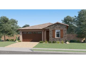 Charming single-story home featuring stone accents, a two-car garage and well manicured lawn at 4951 S 233Rd Dr, Buckeye, AZ 85326