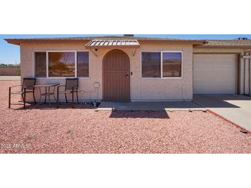 Charming single-story home with a simple front exterior and gravel landscaping at 10018 N 97Th Dr # A, Peoria, AZ 85345