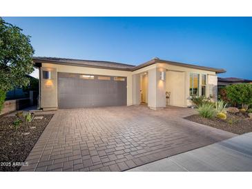 Charming one-story home featuring a brick driveway and desert landscaping at 13330 W Milton Dr, Peoria, AZ 85383