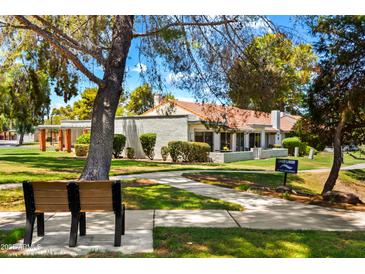 A charming property showcasing a well-kept front lawn and inviting walkway at 156 Leisure World --, Mesa, AZ 85206