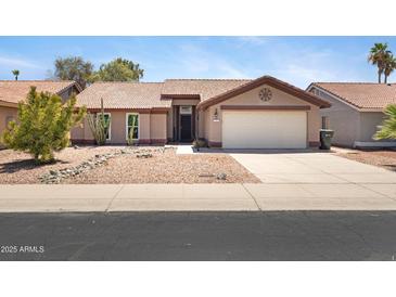 Single story home featuring a terracotta roof, desert landscaping, neutral paint, and two car garage at 16417 S 43Rd Pl, Phoenix, AZ 85048