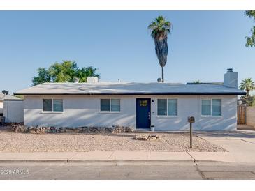 Charming single-story home with a xeriscaped front yard and blue front door at 217 E Bruce Ave, Gilbert, AZ 85234