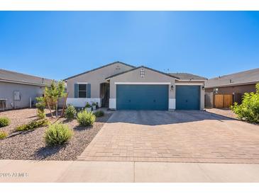 Charming single-story home with a three car garage and beautifully landscaped front yard at 32729 N Mach Ln, San Tan Valley, AZ 85143