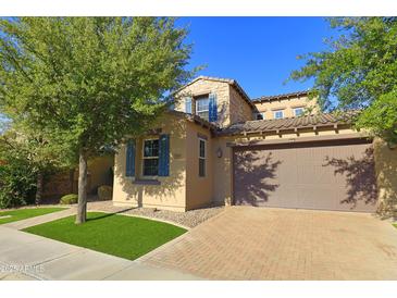 Charming two-story home showcasing a well-manicured lawn, desert landscaping, and a brick-paved driveway leading to a two-car garage at 3581 S Arizona Pl, Chandler, AZ 85286