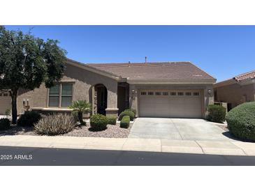 Charming single-story home with a well-manicured front yard and a two-car garage at 4528 E Donato Dr, Gilbert, AZ 85298