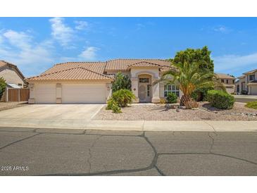 Charming single-story home featuring a spacious garage, desert landscaping, and a welcoming entrance at 592 W Harvard Ave, Gilbert, AZ 85233