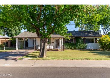 Charming single-story home with well-maintained front yard and mature trees at 743 W Ocotillo Rd, Phoenix, AZ 85013