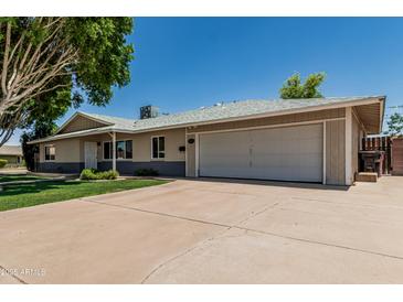 Charming single-story home with a two-car garage and spacious driveway, perfect for suburban living at 8315 E Vernon Ave, Scottsdale, AZ 85257
