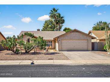 Charming single story home featuring a two car garage and mature desert landscaping at 9839 W Utopia Rd, Peoria, AZ 85382