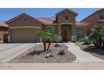 Charming single-Gathering home featuring a well-manicured front yard and inviting curb appeal at 10465 E Knowles Ave, Mesa, AZ 85209