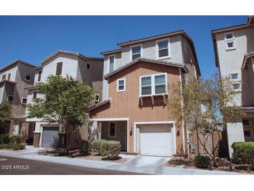 Charming townhome with a two-car garage and well-maintained landscaping at 1183 S Tumbleweed Ln, Chandler, AZ 85286