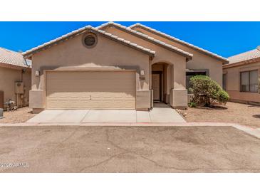 Charming single-story home featuring a two-car garage and landscaped front yard at 125 N 22Nd Pl # 128, Mesa, AZ 85213