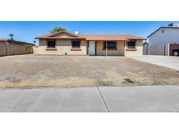 A single-story home featuring a tidy front yard and neutral-toned exterior at 12602 N 38Th Ave, Phoenix, AZ 85029