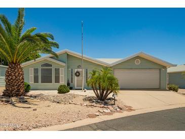 Charming single-story home with a two-car garage and desert landscaping at 215 N Power Rd # 21, Mesa, AZ 85205