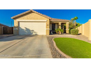 Charming single-story home featuring a two-car garage and desert landscaping at 3532 W Mesquite Ave, San Tan Valley, AZ 85144
