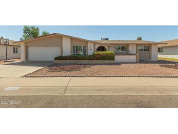 Charming single-story home featuring a low-maintenance desert landscape and attached two-car garage at 4419 W Vogel Ave, Glendale, AZ 85302