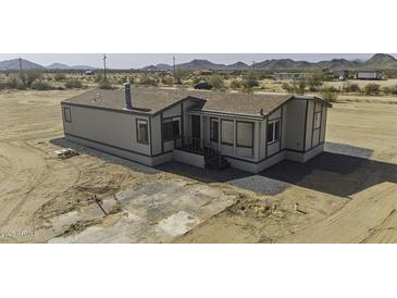 Charming single-story home featuring a covered porch and desert landscape at 53925 W Stallion Rd, Maricopa, AZ 85139