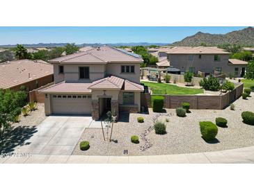 Charming two-story home showcasing landscaped front yard and well-manicured lawn with a pool at 6712 W Miner Trl, Peoria, AZ 85383