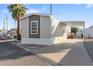 Charming manufactured home with covered parking and well maintained exterior and mature trees at 701 S Dobson Rd # 203, Mesa, AZ 85202