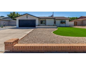 Charming single-story home with well-maintained lawn, desert landscaping, and attached two car garage at 8602 N 42Nd Dr, Phoenix, AZ 85051