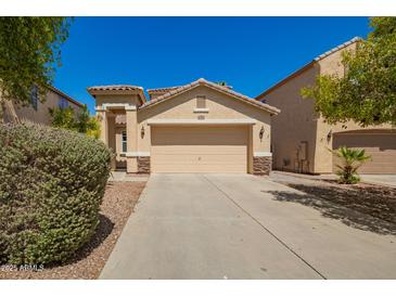 Charming single-story home featuring a two-car garage, desert landscaping, and a welcoming facade at 17493 N Costa Brava Ave, Maricopa, AZ 85139