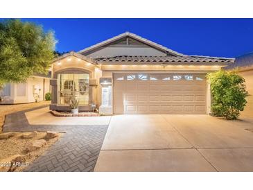 Charming single story home features a manicured lawn and attached two car garage at 3404 E Lavey Ln, Phoenix, AZ 85032