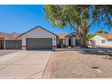 Charming single-story home featuring a well-manicured lawn, desert landscaping, and a two-car garage at 3608 W Fairview Ln, Chandler, AZ 85226