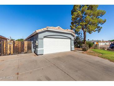 View of the home's two-car garage and spacious driveway with plenty of parking space at 403 N Monte Vista St, Chandler, AZ 85225