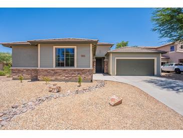 Charming single story home with stone accents, desert landscaping, and attached two car garage at 5434 W T Ryan Ln, Laveen, AZ 85339