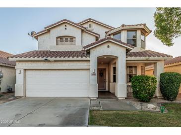 Charming two-story home featuring a white stucco exterior, a tile roof, and a well-maintained front yard with mature landscaping at 6846 S 26Th Pl, Phoenix, AZ 85042