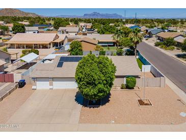 Expansive aerial view of a single-Gathering home featuring a two-car garage, solar panels, and a lush front yard at 823 N 81St St, Mesa, AZ 85207
