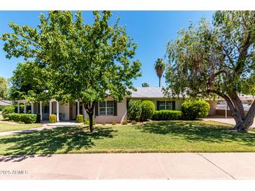 Charming single story home featuring a well maintained lawn, mature trees, and manicured landscaping at 840 E 2Nd St, Mesa, AZ 85203