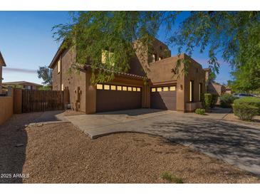 Two-story stucco home with brown garage doors, a low-maintenance front yard, and desert landscaping at 8503 W Coyote Dr, Peoria, AZ 85383