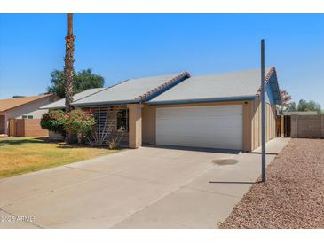 Charming single-story home with a two-car garage and well-maintained front yard at 1407 W Chilton St, Chandler, AZ 85224