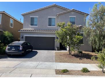 Charming two-story home featuring a paver driveway, two car garage and low maintenance desert landscaping at 18400 W Ipswitch Way, Surprise, AZ 85374