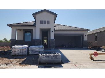 Craftsman style home with stone accents, a two-car garage, and a covered porch under construction at 2317 S 125Th Dr, Avondale, AZ 85323