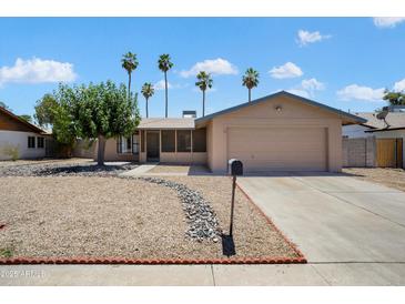 Charming single story home with a two-car garage and low maintenance landscaping at 5227 W Acapulco Ln, Glendale, AZ 85306