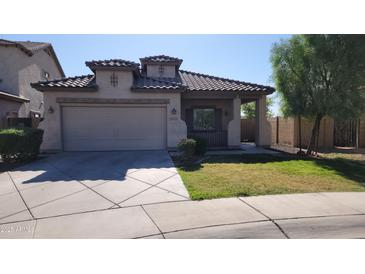 Charming single-story home featuring a 2-car garage and a cozy front porch at 6908 S 54Th Ln, Laveen, AZ 85339