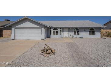 Charming single-story home featuring a two-car garage and a well-manicured, desert-landscaped front yard at 742 S Rose --, Mesa, AZ 85204
