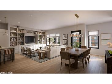 Open-concept living room features modern decor, built-in shelving, and natural light at 19360 N 73Rd St # 1081, Scottsdale, AZ 85255