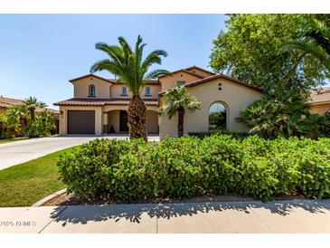 Inviting two-story home with a three-car garage and mature landscaping including palm trees at 41448 N Eliana Dr, Queen Creek, AZ 85140