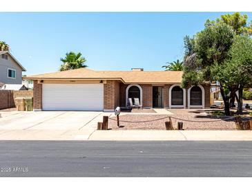 Charming single-story brick home featuring a well-maintained yard and a two-car garage at 5302 W Poinsettia Dr, Glendale, AZ 85304
