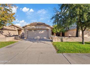 Charming single story home with a two car garage, large driveway and well-maintained lawn at 5734 W Commonwealth Pl, Chandler, AZ 85226