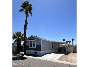 Charming single-story home with carport and well-manicured landscaping at 625 W Mckellips Rd # 325, Mesa, AZ 85201