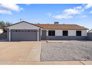 Charming single-story home featuring a gray garage door and a low-maintenance front yard at 7008 W Sierra St, Peoria, AZ 85345