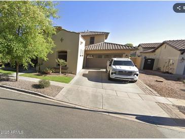 Charming home with a two-car garage and well-manicured front yard at 13687 N 151St Ln, Surprise, AZ 85379